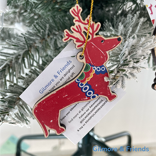 Gilmore & Friends short sleeve t- shirt knitted sweater in green with blue trim and a black line drawing of a dachshund head with a beret on top